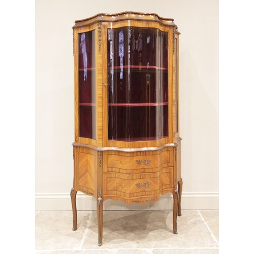 693 - A Louis XV style kingwood vitrine, mid 20th century, the single serpentine glazed door opening to a ... 