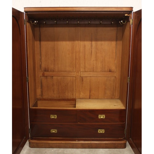 683 - A large Victorian mahogany wardrobe, the rectangular wardrobe designed with two cupboard doors appli... 