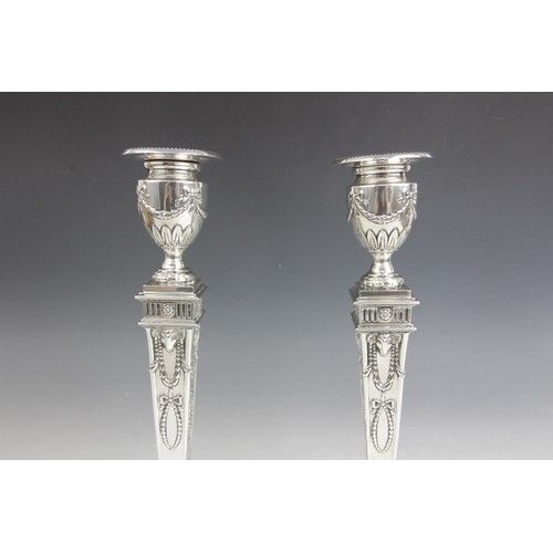 35 - A pair of George V neo-classical silver candlesticks, Ellis & Co, Birmingham 1914, each weighted squ... 