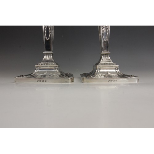 35 - A pair of George V neo-classical silver candlesticks, Ellis & Co, Birmingham 1914, each weighted squ... 