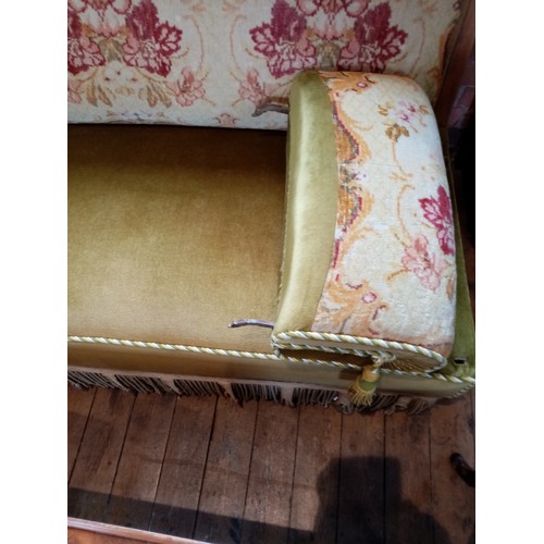 697 - A Victorian sofa, the upholstered floral tapestry back rest within a carved walnut frame, extending ... 