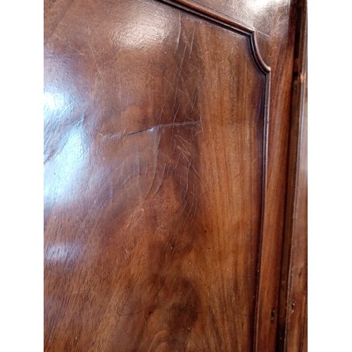 718 - A 19th century mahogany linen press, the dentil cornice above a pair of cupboard doors, applied with... 