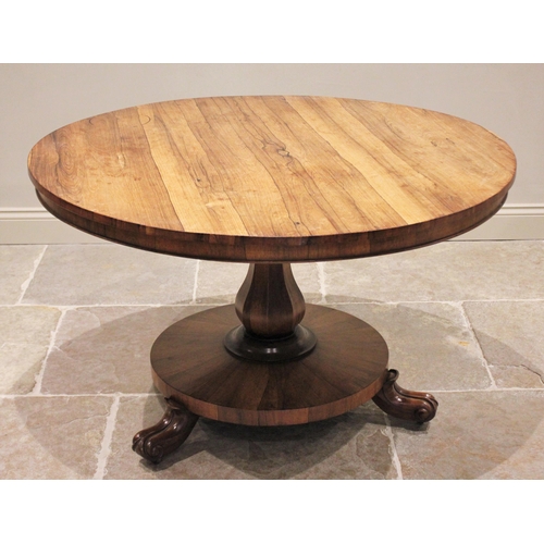 679 - A mid 19th century rosewood pedestal breakfast table, the circular tilt top raised upon an octagonal... 