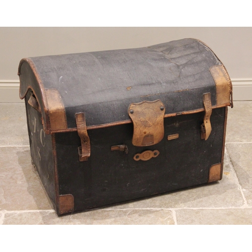 703 - An early 20th century domed canvas motoring trunk, applied with tan leather trim and side handles, a... 