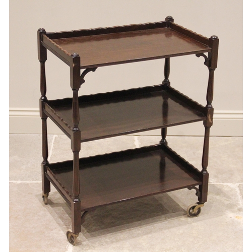 707 - A mahogany tea trolley by Ray and Mills, Liverpool, circa 1920, the three galleried tiers united by ... 