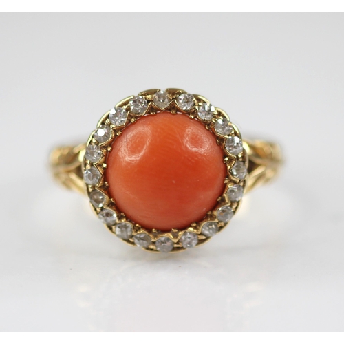 71 - A Victorian coral and diamond 18ct gold ring, the central coral cabochon measuring 9.5mm diameter, w... 