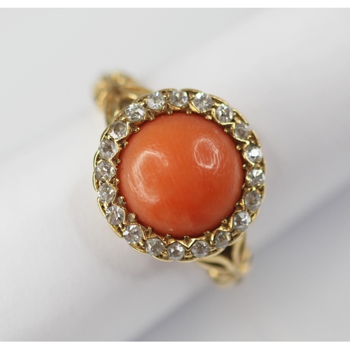 71 - A Victorian coral and diamond 18ct gold ring, the central coral cabochon measuring 9.5mm diameter, w... 