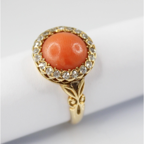 71 - A Victorian coral and diamond 18ct gold ring, the central coral cabochon measuring 9.5mm diameter, w... 