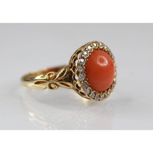 71 - A Victorian coral and diamond 18ct gold ring, the central coral cabochon measuring 9.5mm diameter, w... 