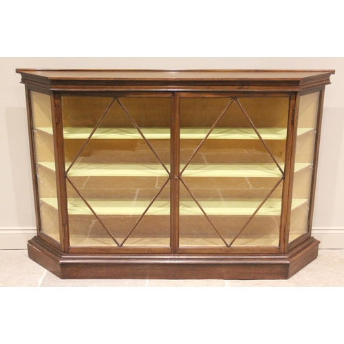 711 - An Edwardian mahogany and later constructed display cabinet, of angular bowfront form, the pair of a... 