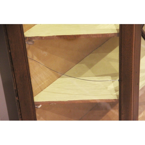 711 - An Edwardian mahogany and later constructed display cabinet, of angular bowfront form, the pair of a... 