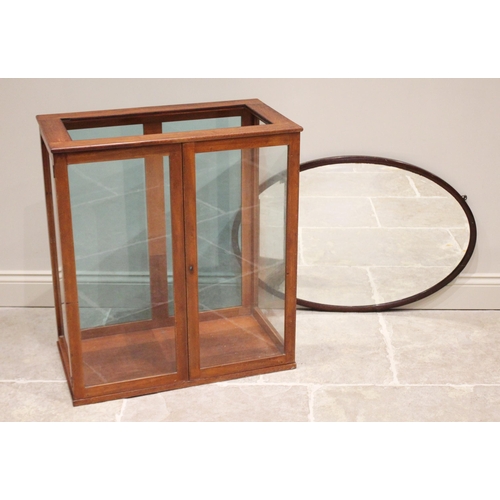 715 - An early 20th century glazed mahogany counter top display cabinet, with a pair of hinged doors, glaz... 