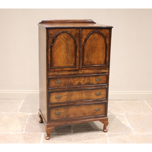 719 - A 1930's Queen Anne style figured walnut tall boy, the rectangular moulded top above a pair of cupbo... 