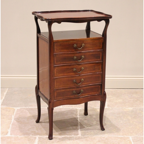 720 - An Edwardian mahogany music cabinet, with an  elevated serpentine tray top, above a recess and five ... 