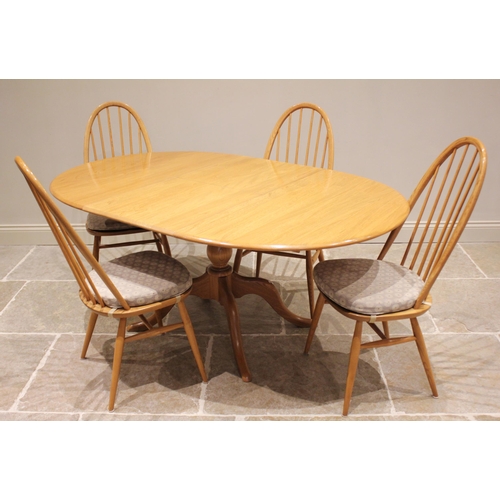 733 - An Ercol 'Chester' elm and beech extending oval pedestal table and four conforming Ercol chairs, the... 