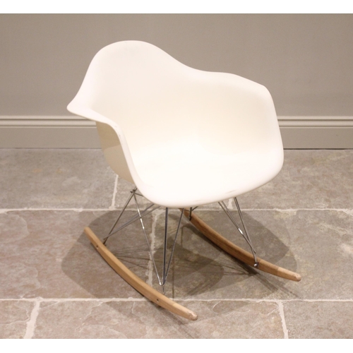 739 - An Eames type rocking chair, late 20th century, the white moulded tub seat raised upon a chromed met... 