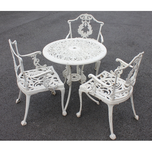 745 - A 19th century style painted metal patio table and three chairs, the chairs cast with openwork scrol... 