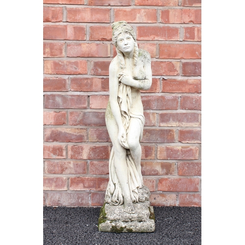 746 - A reconstituted stone garden statue, modelled as a classical scantily clad female upon an integrated... 