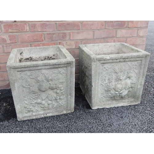 740 - A pair of reconstituted planters, of cubic form, each moulded in relief with foliate and fruit detai... 