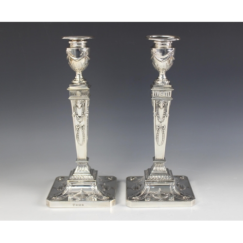 8 - A pair of George V neo-classical silver candlesticks, Ellis & Co, Birmingham 1914, each weighted squ... 