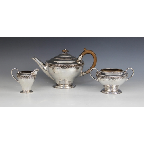 3 - A George V three-piece silver tea service, Harold Edwin Landon, Chester 1932, each of compressed for... 