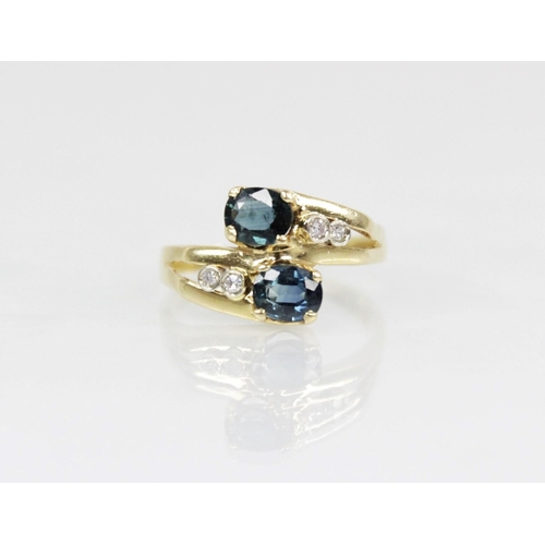 68 - A continental sapphire and diamond 18ct gold crossover ring, designed as two oval mixed cut sapphire... 