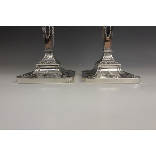 8 - A pair of George V neo-classical silver candlesticks, Ellis & Co, Birmingham 1914, each weighted squ... 