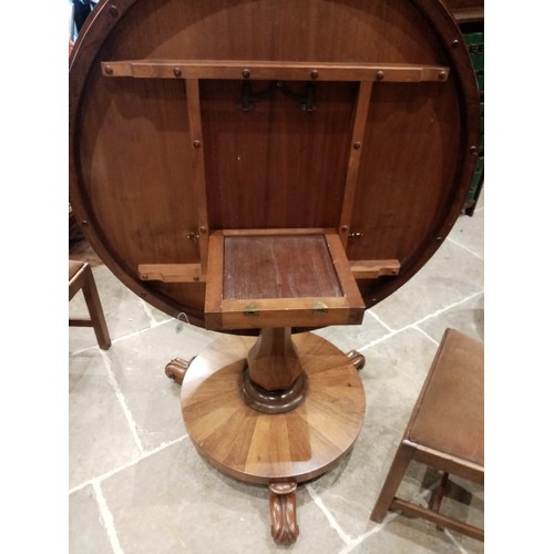 679 - A mid 19th century rosewood pedestal breakfast table, the circular tilt top raised upon an octagonal... 