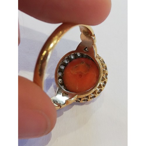 71 - A Victorian coral and diamond 18ct gold ring, the central coral cabochon measuring 9.5mm diameter, w... 