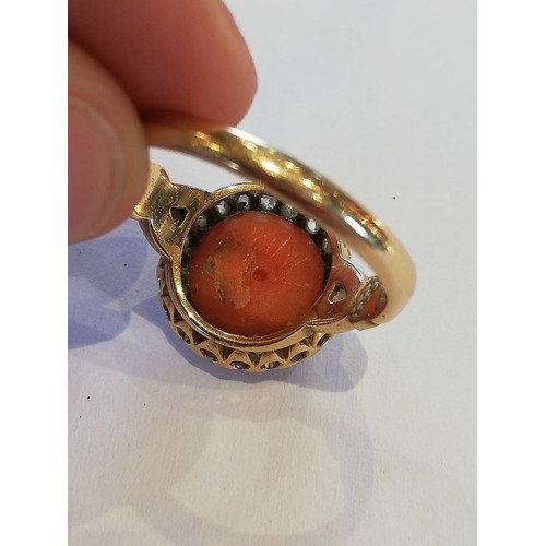 71 - A Victorian coral and diamond 18ct gold ring, the central coral cabochon measuring 9.5mm diameter, w... 