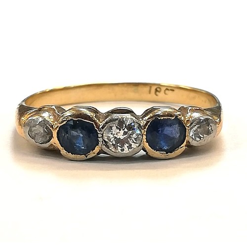 76 - An early 20th century sapphire and diamond five-stone ring, the central round old cut diamond weighi... 