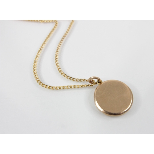 111 - A Victorian 15ct gold locket pendant, of circular form, opening to reveal a vacant aperture, stamped... 