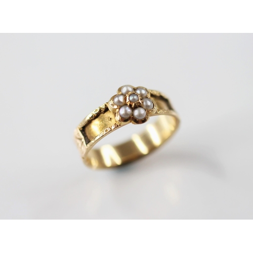 113 - A 19th century pearl set memorial ring, designed as a floral cluster set with half pearls, set upon ... 