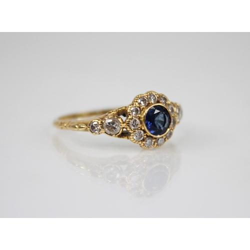 117 - An early 20th century sapphire and diamond floral cluster ring, the central round mixed cut sapphire... 