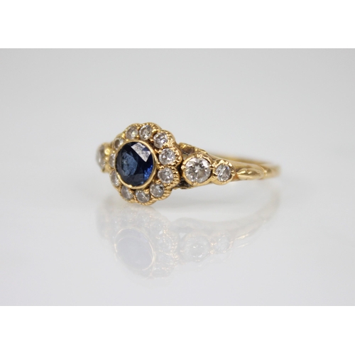 117 - An early 20th century sapphire and diamond floral cluster ring, the central round mixed cut sapphire... 