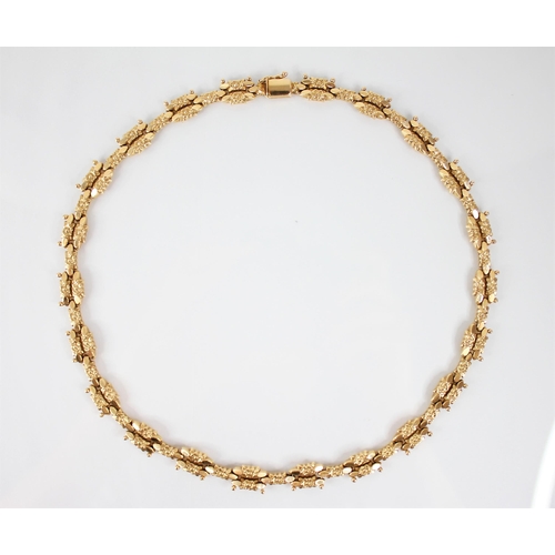 120 - A continental 18ct gold necklace, designed as cast floral lozenge shaped links with beaded detail, t... 