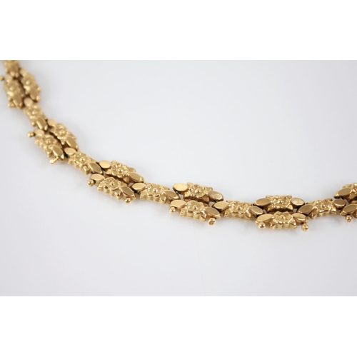 120 - A continental 18ct gold necklace, designed as cast floral lozenge shaped links with beaded detail, t... 