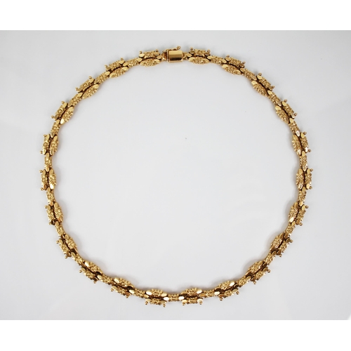 120 - A continental 18ct gold necklace, designed as cast floral lozenge shaped links with beaded detail, t... 