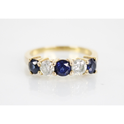 123 - A sapphire and diamond five stone ring, the central round mixed cut blue sapphire measuring 4.6mm di... 