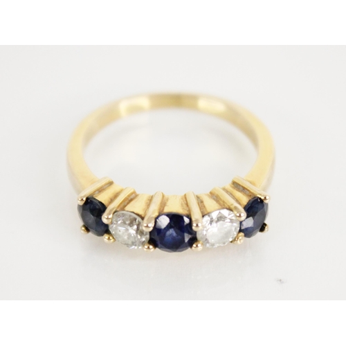 123 - A sapphire and diamond five stone ring, the central round mixed cut blue sapphire measuring 4.6mm di... 