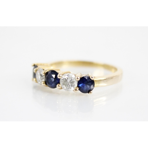 123 - A sapphire and diamond five stone ring, the central round mixed cut blue sapphire measuring 4.6mm di... 