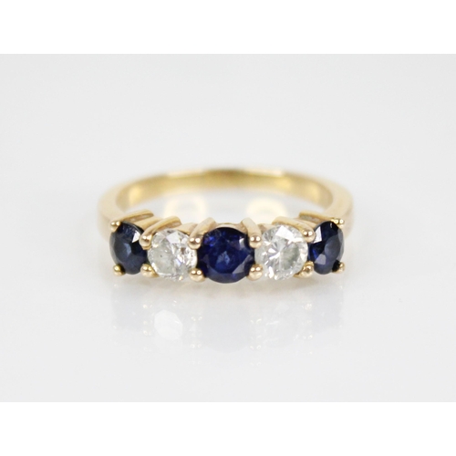 123 - A sapphire and diamond five stone ring, the central round mixed cut blue sapphire measuring 4.6mm di... 