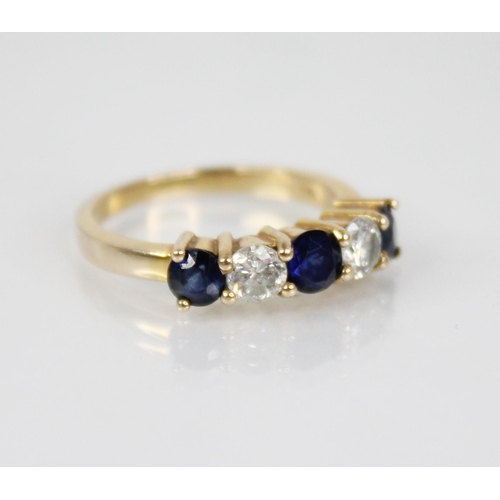 123 - A sapphire and diamond five stone ring, the central round mixed cut blue sapphire measuring 4.6mm di... 