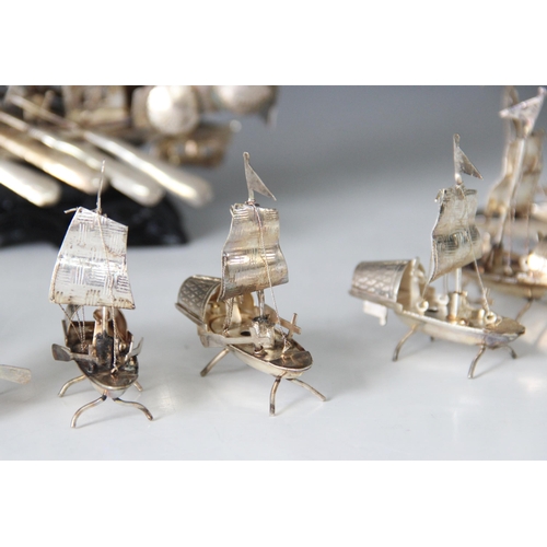 20 - A Chinese silver coloured model of a junk ship, modelled with three masts in full sail, eight ores a... 