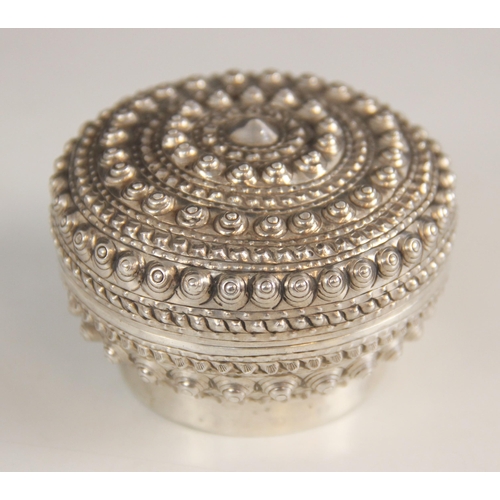24 - A Chinese silver coloured box and cover, of circular form on raised foot, elaborately decorated with... 