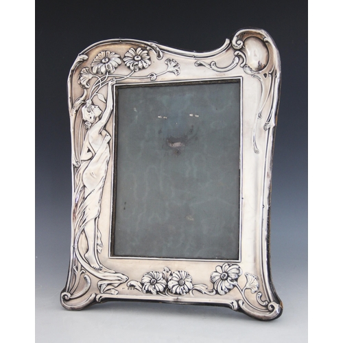 30 - An Art Nouveau silver photograph frame, Samuel M Levi, Birmingham 1907, of shaped rectangular form, ... 