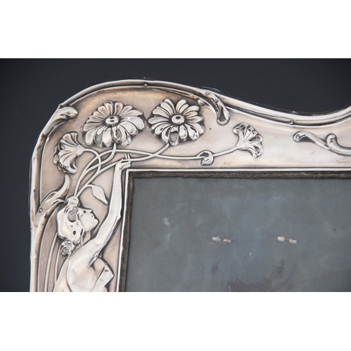 30 - An Art Nouveau silver photograph frame, Samuel M Levi, Birmingham 1907, of shaped rectangular form, ... 
