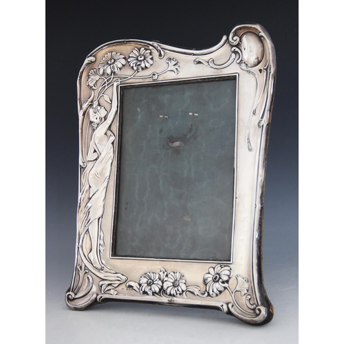 30 - An Art Nouveau silver photograph frame, Samuel M Levi, Birmingham 1907, of shaped rectangular form, ... 