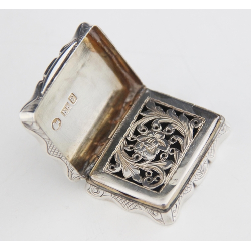 47 - A Victorian silver vinaigrette, Edward Smith, Birmingham 1847, of shaped rectangular form, the cover... 