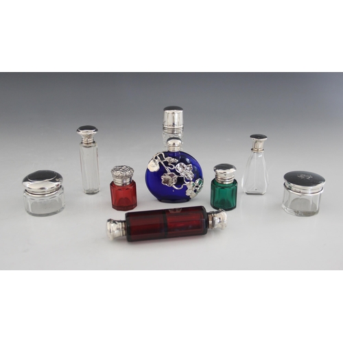 52 - A selection of silver, silver coloured and cut glass scent bottles and vanity jars, to include; an E... 